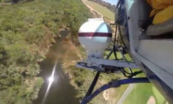 Helicopter dropping larvicide